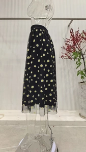 Detail of black tulle midi skirt featuring white daisy prints and an elastic high waistband