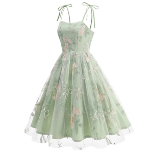 Detail of floral embroidery on light green mesh dress with elegant tie shoulder straps