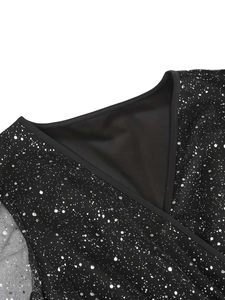 Close-up of V-neck cross neckline with sheer mesh fabric and silver starburst print