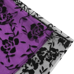 Close-up of vintage purple fabric with black floral flocked mesh and lace detail