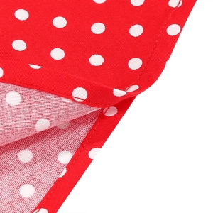 Detailed close-up of red and white polka dot cotton fabric with high-quality stitching