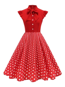 Detail of red retro dress featuring a bow tie collar, front buttons and ruffle cap sleeves