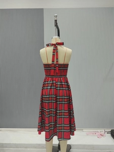 Detail of red plaid dress showing back ribbon bow and smocked elastic waist