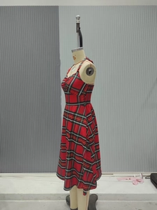 Detail of red and green tartan midi dress with pleated neckline and sleeveless design
