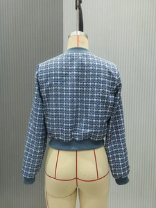 Rear view of a blue and white checkered short jacket featuring navy ribbed knit trims