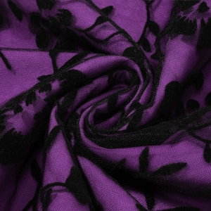Macro view of purple mesh fabric with black floral velvet flocking pattern detail