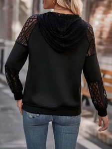 Detailed back view of black lace patchwork hoodie featuring hollow geometric embroidery