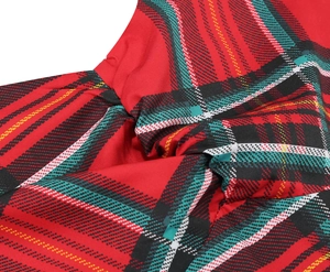 Detailed macro shot of the elegant red tartan plaid fabric and stylish twist knot design