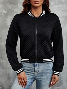 Detailed view of black quilted jacket with striped ribbed collar and metal zip closure