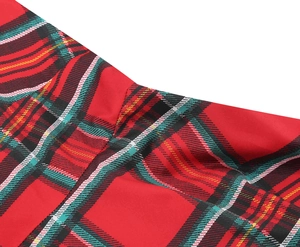 Macro detail of Christmas plaid dress fabric with red green check pattern and neat stitching