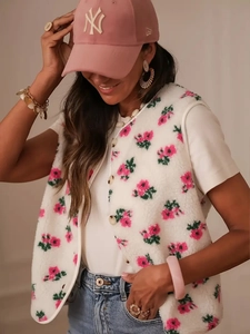 Close-up of women's floral fleece vest featuring pink roses and soft textures