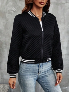 Detail of black quilted bomber jacket with striped ribbed cuffs and metal zipper closure