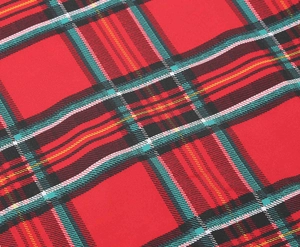 Close-up of red plaid tartan fabric with high-quality textile texture and interlaced patterns