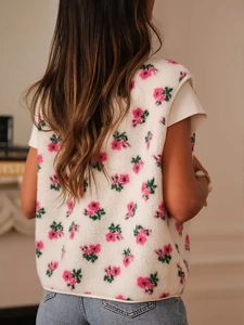 Detail shot of the floral fleece vest's soft texture and warm pink flower patterns