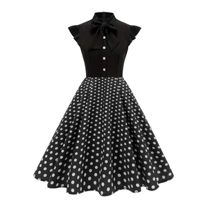 Vintage Audrey Hepburn style dress with black bodice, bow neckline and white polka dot skirt