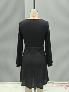 Detailed back view of a slim-fit black ribbed knit dress on a mannequin with high waistline