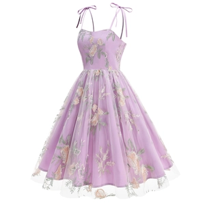 Close-up of floral embroidery on purple tulle dress with adjustable ribbon straps