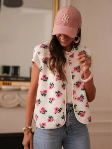 Detail of floral embroidery on a white fleece vest with single-breasted button closure