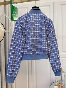 Rear view of a blue and white checkered tweed bomber jacket with ribbed knit trims