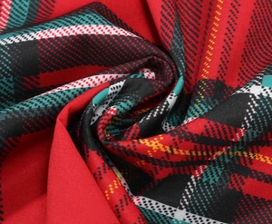 Close-up of classic red and green plaid fabric with detailed weave for Christmas dress