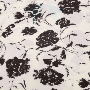 Gros plan sur un tissu à imprimé floral noir et blanc avec une texture mousseline