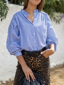 Close-up of a blue and white striped long sleeve shirt with a mandarin collar and lantern sleeves