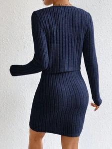 Rear view detail of dark blue ribbed knit two-piece set with fitted top and skirt