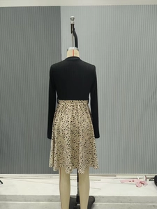 Back view of a long-sleeved dress featuring black top and floral print skirt detail