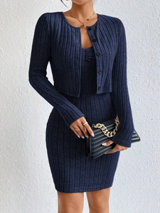 Detail of dark blue ribbed knit two-piece set featuring slim cardigan and midi dress