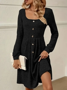 Detail of square neckline and front buttons on a black ribbed knit long sleeve dress