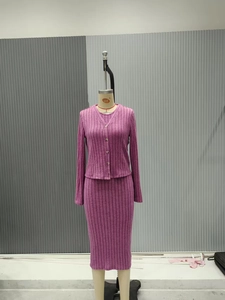 Detail of burgundy ribbed knit cardigan and matching high-waisted midi skirt set