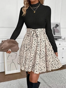 Detail of long sleeve knit top and floral print skirt with waist bow on the midi dress