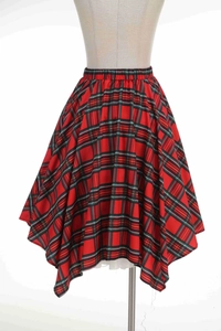 Détail de jupe écossaise rouge avec taille élastique, ourlet asymétrique et tulle