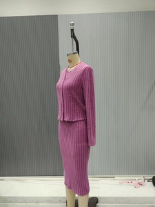 Detail of burgundy ribbed knit long sleeve cardigan and matching slim skirt set