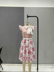 Detail of pink sleeveless top with bow and rose floral skirt on mannequin