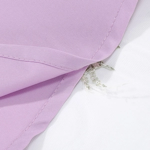 Detail of purple dress fabric stitching with pink sequins and silver embroidery on mesh