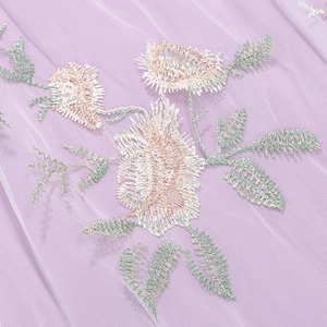 Detail of silver floral embroidery on lavender mesh tulle fabric for a vintage dress