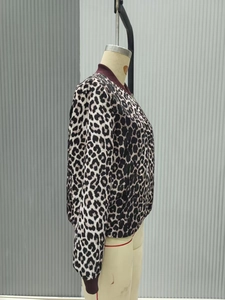 Close-up of leopard print bomber jacket with burgundy ribbed collar and zipper detail