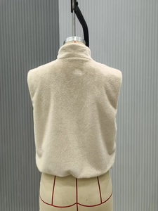 Back view of a beige faux fur vest showing the stand collar and soft plush texture