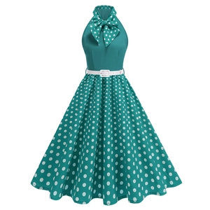 Detail of vintage peacock green halter dress with white polka dots and a large bow