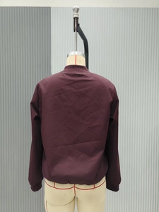 Back view of a burgundy reversible bomber jacket with ribbed collar and hem detail