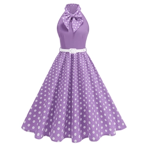 Detail of retro purple polka dot dress featuring a halter neck and white bow design