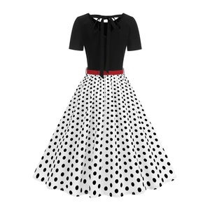 Close-up of vintage polka dot dress featuring back hollow cut-out and red bow tie detail