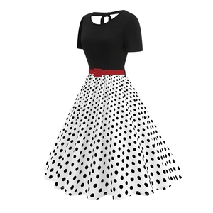 Detailed view of the red decorative belt on the vintage black and white polka dot dress