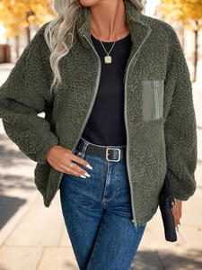 Detail of army green sherpa fleece jacket featuring high collar and zip pocket