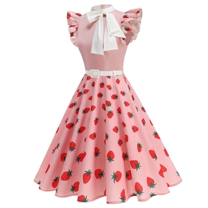 Detail of pink vintage dress featuring strawberry print and large white bow neckline
