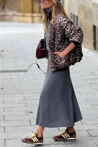 Detail of leopard print standing collar jacket paired with grey maxi skirt for autumn style