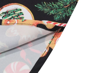 Macro shot of Christmas print dress hem with gingerbread men and tree motifs
