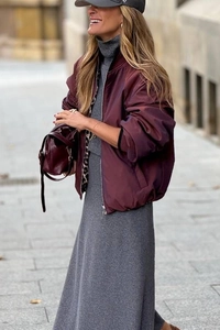 Detail of burgundy satin bomber jacket with leopard print lining and matching handbag