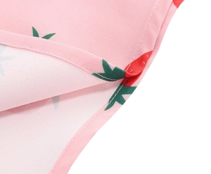 Detail of pink vintage dress showing strawberry floral print and neat hem stitching